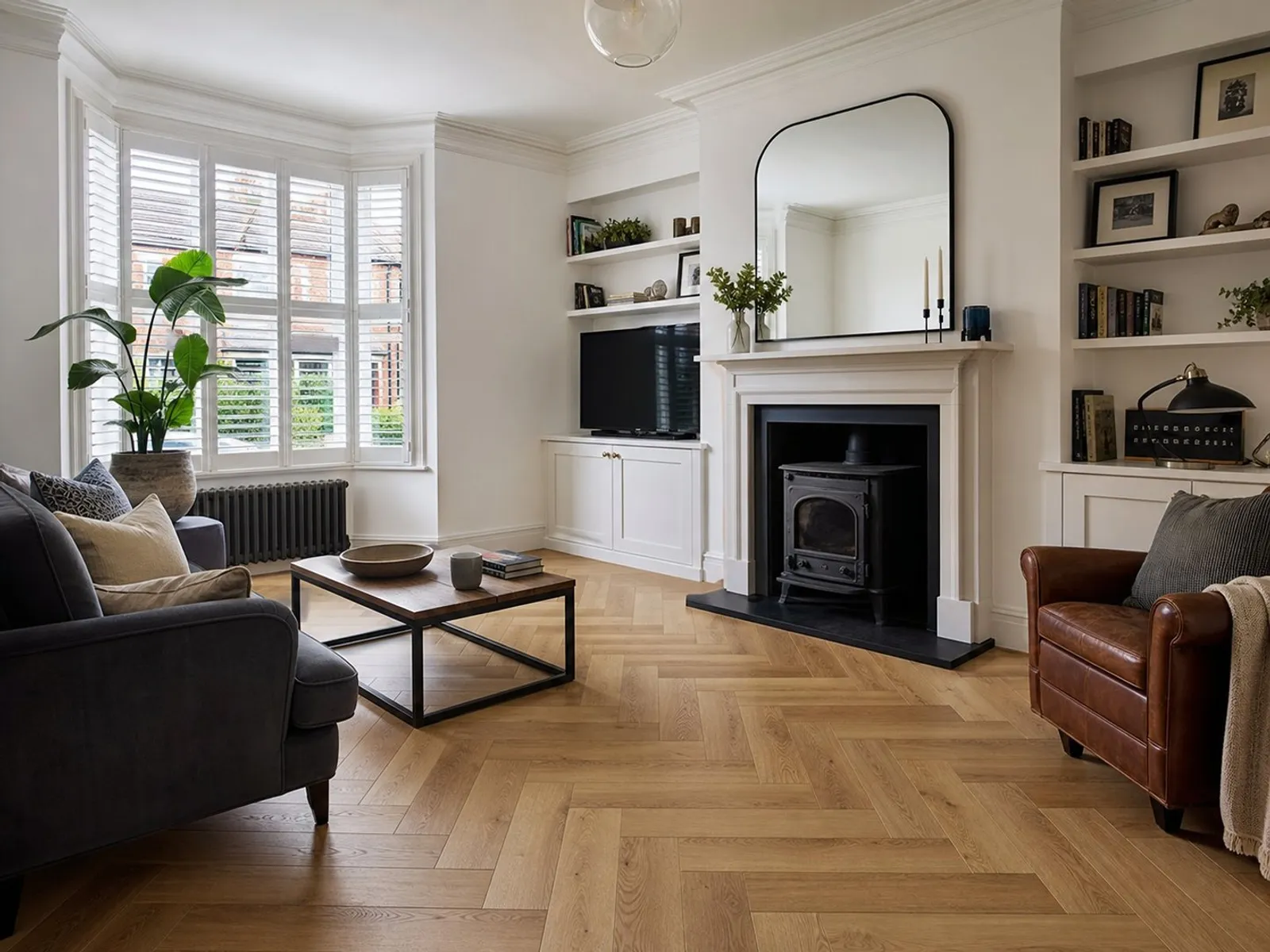 Herringbone engineered wood flooring installed in a bright living room